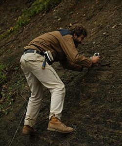 geology student examining rocks